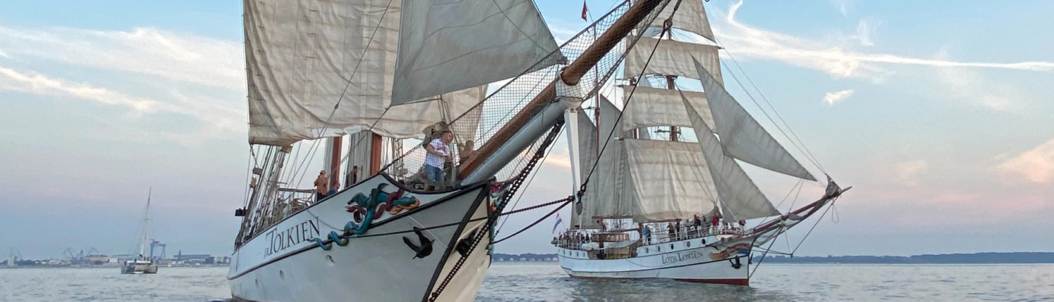 Classic sailing ships Loth Loriën and J.R. Tolkien sailing in formation – charter-ready tallships